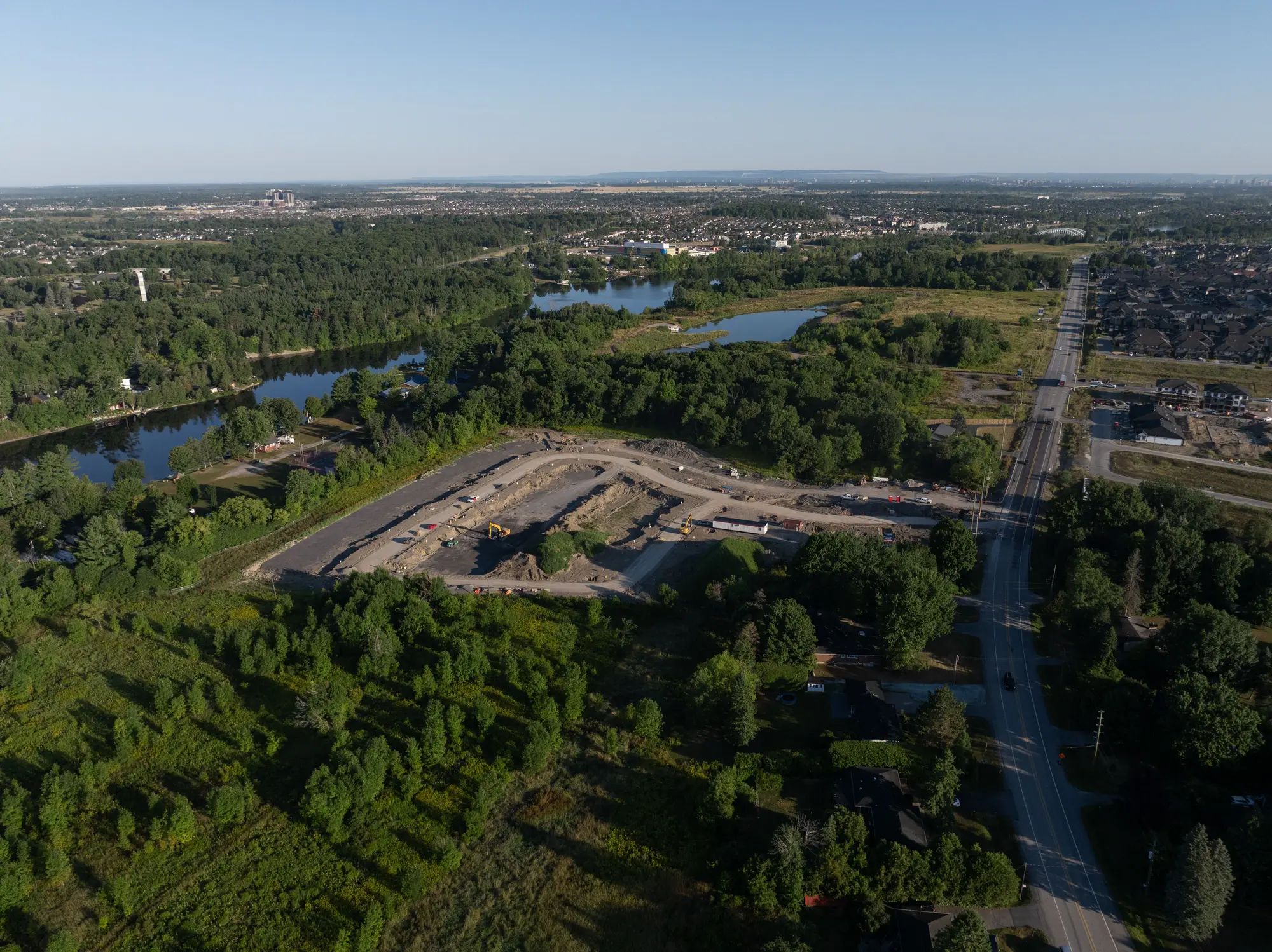 Aerial view of a rehabilitated landscape with ponds beside a residential community