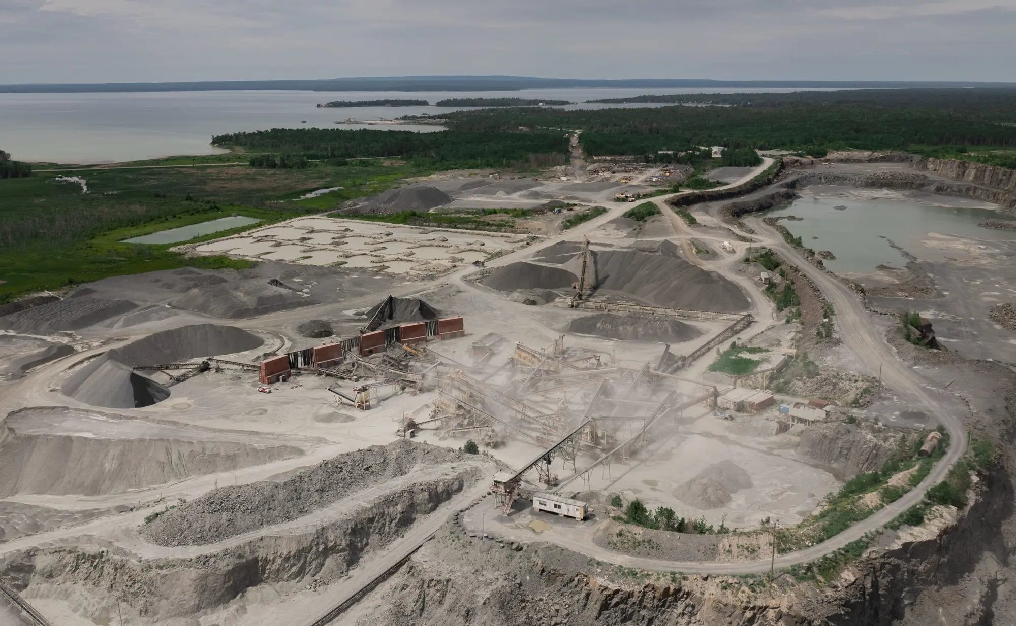Aerial view of a Tomlinson sand and gravel pit with a below-water-table extraction pond